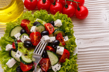 Greek salad on a wooden rustic background