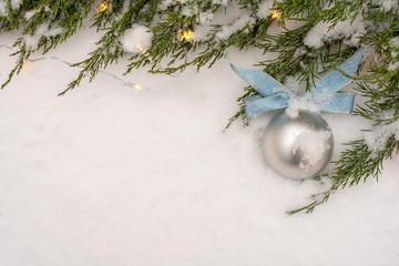 Christmas and New Year background. Snowflake, Christmas tree and ball on a white snow background.