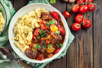Hungarian beef goulash serwed with galuska noodles - obrazy, fototapety, plakaty