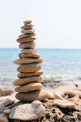 Fototapeta na wymiar inspirational pile of stones, man made, well balanced and stacked seaside