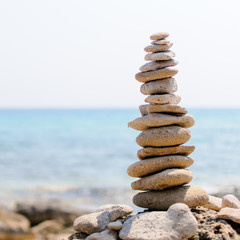 Fototapeta na wymiar inspirational pile of stones, man made, well balanced and stacked seaside