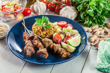 Traditional pork satay with peanut sauce and vegetables