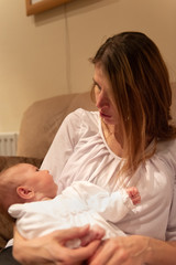 Obraz na płótnie Canvas Mother looking at newborn