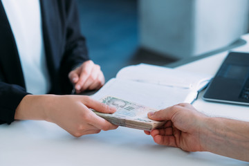 woman receiving money in office. business bribery and illegal payments