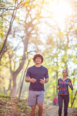 fitness Couple jogging and running outdoors in nature- healthy lifestyle training.