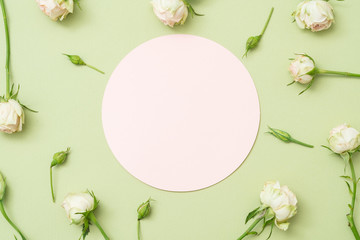 greeting card mockup. white empty round paper with roses layout on green background