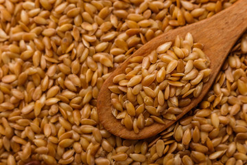 Seeds of golden flax on a white background