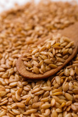 Seeds of golden flax on a white background