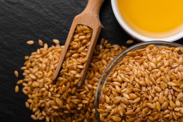 seeds of golden flax on a dark stone background