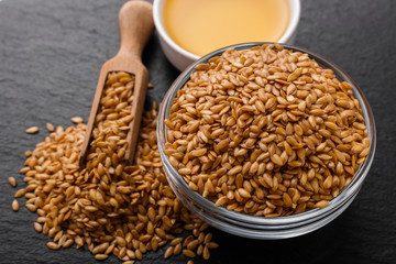 seeds of golden flax on a dark stone background