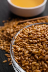 seeds of golden flax on a dark stone background