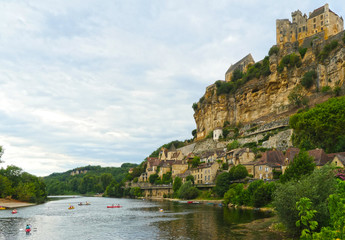 Beynac et Cazenac with some kayaks in the Dordogne River and the Castle on the top