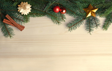 green christmas frame with fir branches on bright wood