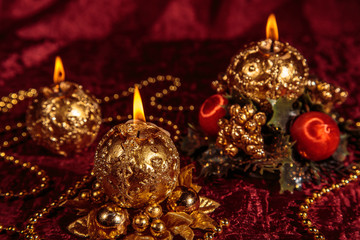 Fototapeta na wymiar Christmas still life with spherical candles on Burgundy background