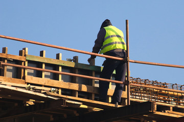 Naklejka premium Safety risc worker without helmet at the construction site