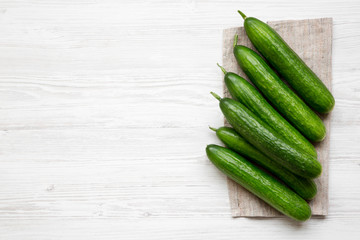 Raw green cucumbers, top view. Flat lay, overhead, from above. Copy space.