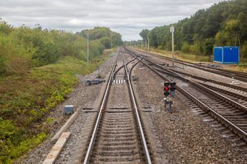 Railway. View from the window of the last train car or from the cab. Russian autumn landscape. Railway rails and sleepers.