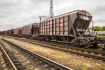 Fototapeta na wymiar Cars of a freight train at the station. Railway rails and sleepers.