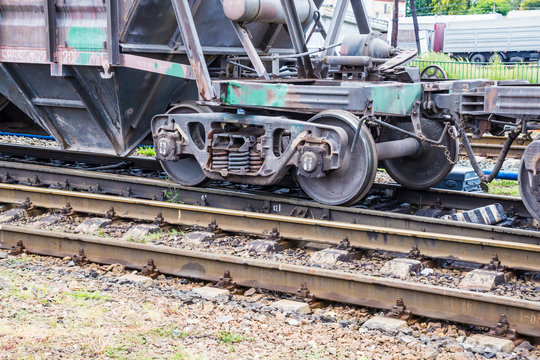 Cars of a freight train at the station. Railway rails and sleepers.