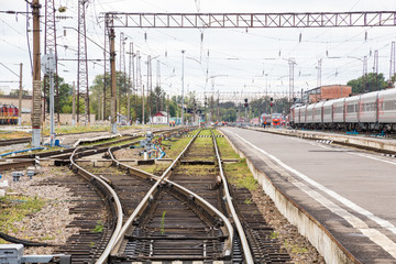 Railway rails, sleepers and platform at the station. Provincial town in Russia.