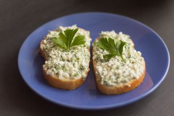 sandwiches with cottage cheese and herbs on a blue plate