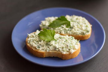 sandwiches with cottage cheese and herbs on a blue plate