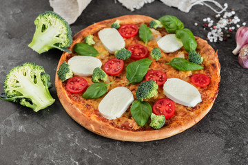 Pizza, food, vegetable, margarita.  Vegetables, mushrooms and tomatoes pizza on a black wooden background. It can be used as a background