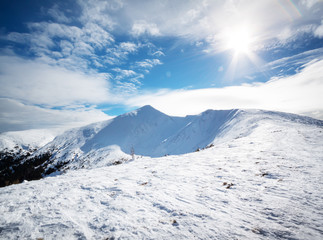 Mountain peak in the snow under the bright sun