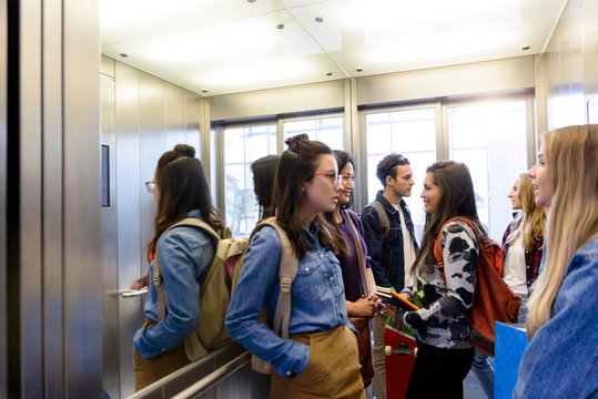 University students talking inside elevator