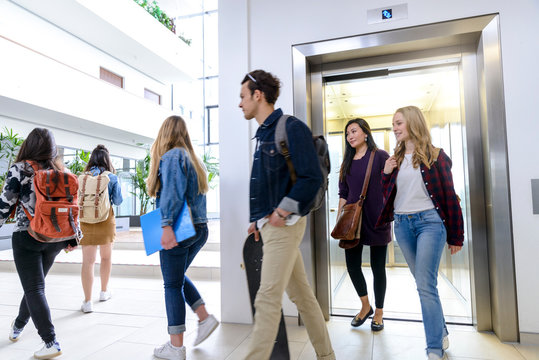 University students exiting elevator in campus