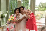 Wedding guests taking selfie at reception