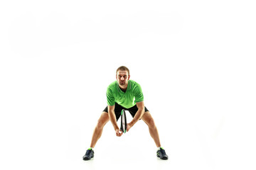 Naklejka na ściany i meble The one caucasian man playing tennis isolated on white background. Studio shot of fit young player at studio in motion or movement during sport game..