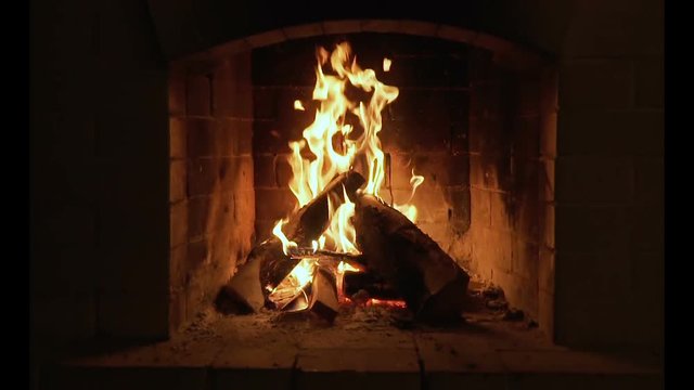 A looping clip of a fireplace with medium size flames. Burning Fire In The Fireplace. Slow motion.