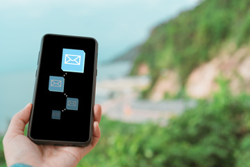 Woman hand using smartphone to send and recieve email.