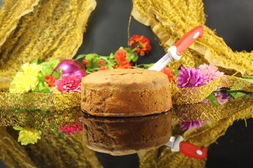 Plum cake placed on a table decorated with flowers