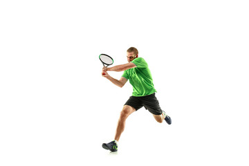 The one caucasian man playing tennis isolated on white background. Studio shot of fit young player at studio in motion or movement during sport game..