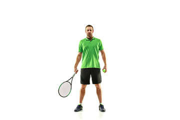 The one caucasian man playing tennis isolated on white background. Studio shot of fit young player at studio in motion or movement during sport game..