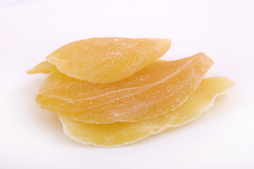 Candied fruit mango in sugar on a white background.