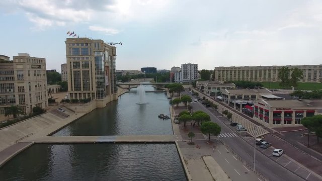 Council of Montpellier administrative building in front of river Lez aerial drone view.