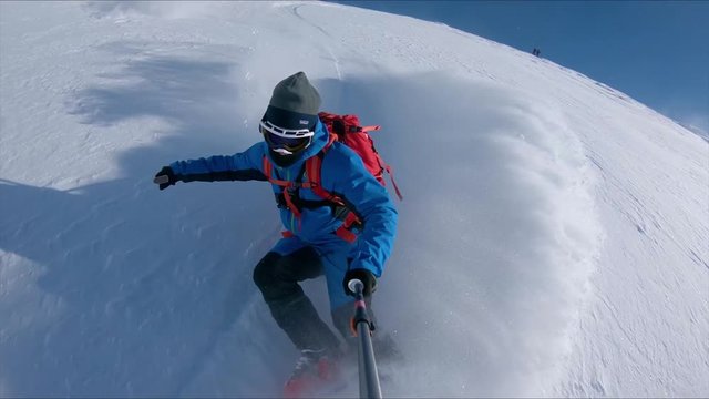 SLOW MOTION: Extreme freeride skier shreds the snow off piste on a sunny day in Japanese mountains. Pro skier rides the fresh powder snow in the backcountry of Niseko. Awesome outdoor winter sport.