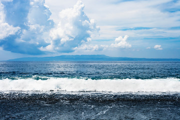 Summer landscape black sand beach in Bali, Indonesia