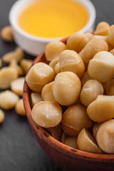 delicious macadamia nuts on a dark stone background