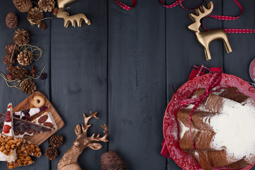 Italian Christmas cupcake with powdered sugar. Traditional festive pastries and sweets with nuts, fruit, caramel and nougat. Top view as a frame. Free space for text.