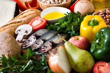 Healthy eating. Mediterranean diet. Fruit,vegetables, grain, nuts olive oil and fish on wooden table. 