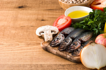 Healthy eating. Mediterranean diet. Fruit,vegetables, grain, nuts olive oil and fish on wooden table. Copyspace