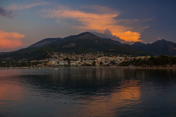 twilight evening Mediterranean landscape with village between lonely mountain and sea shore