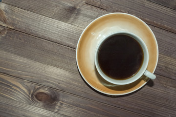 a Cup of coffee on a dark wooden table.