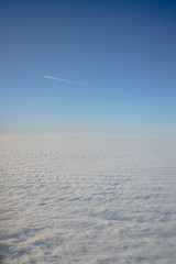 Clouds from the airplane window, from above, the sky above the ground, from the plane.