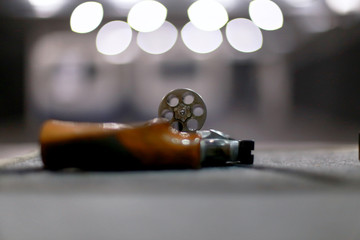 Handgun in the shooting range in backlight
