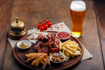 Big set of snacks for beer or alcohol and it includes smoked pork meat, french fries, fried bread, crab sticks and nuts
